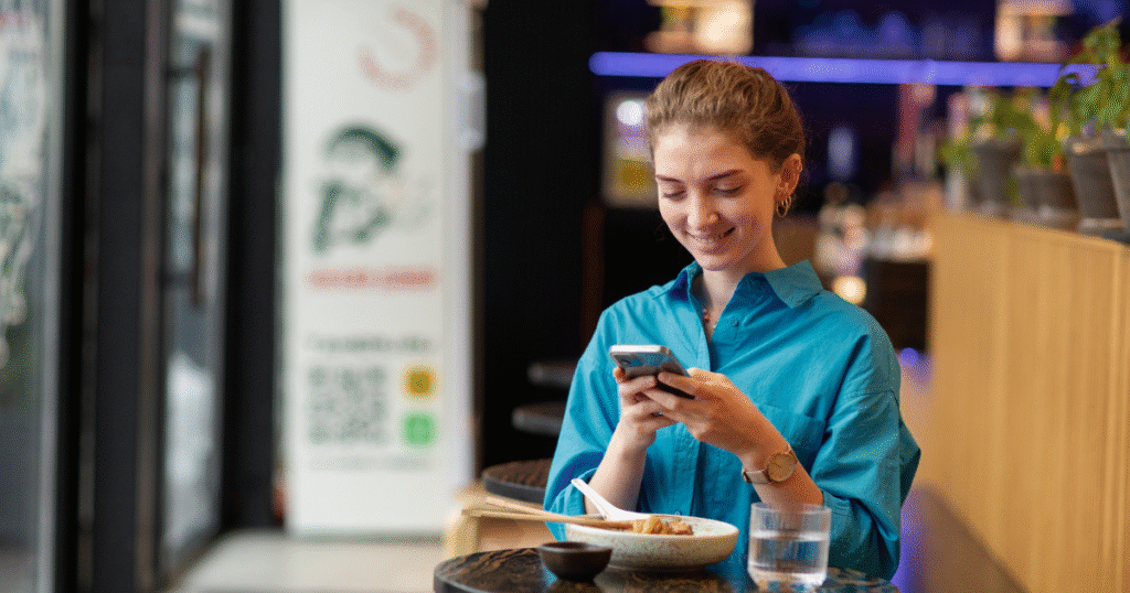 a customer sitting in a restaurant and using Swizzle - cloud restaurant management software